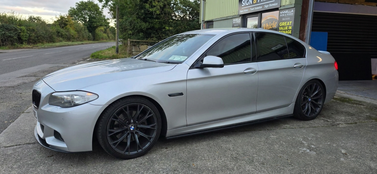 Front-left view of a tinted silver BMW saloon