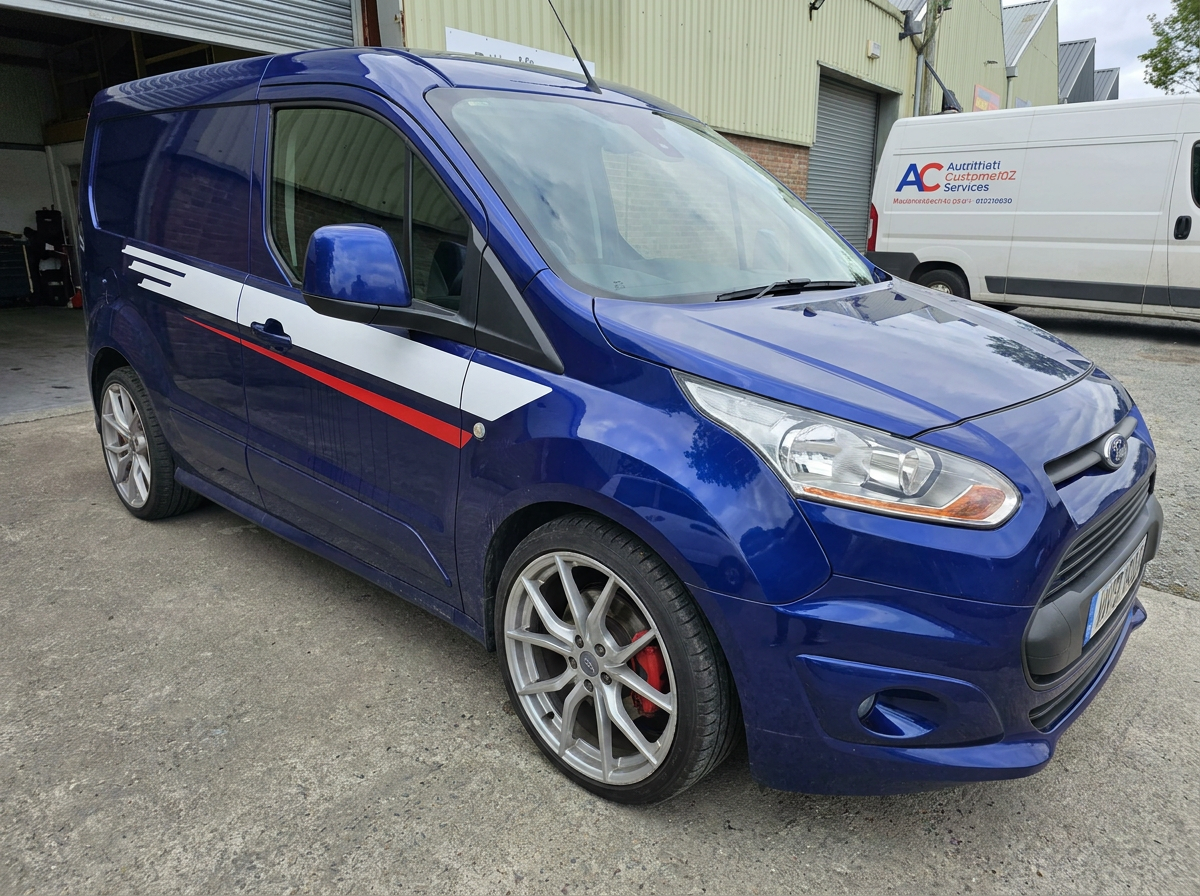 Front-right view of a blue Transit Connect Sport van after window tinting