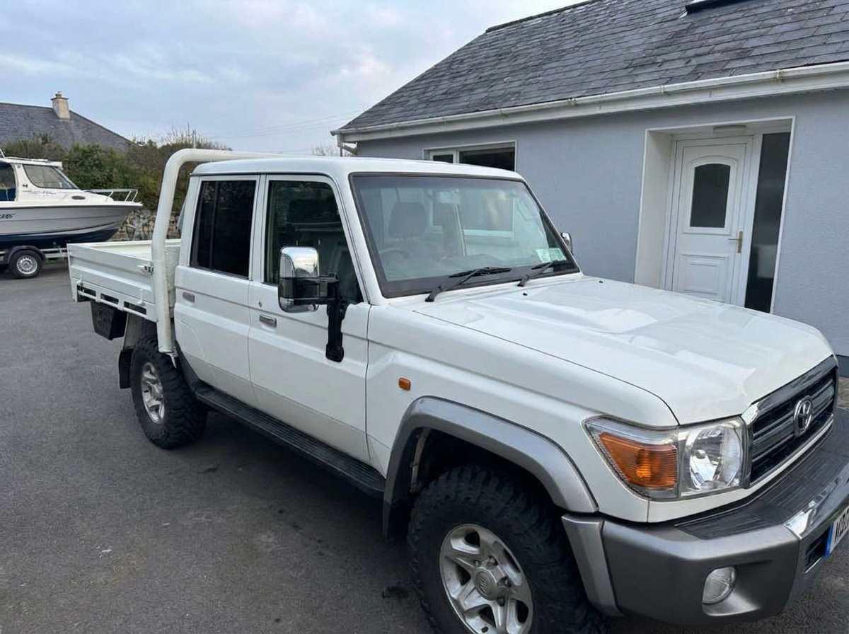 Front-right view of a white Land Cruiser crew cab after tinting