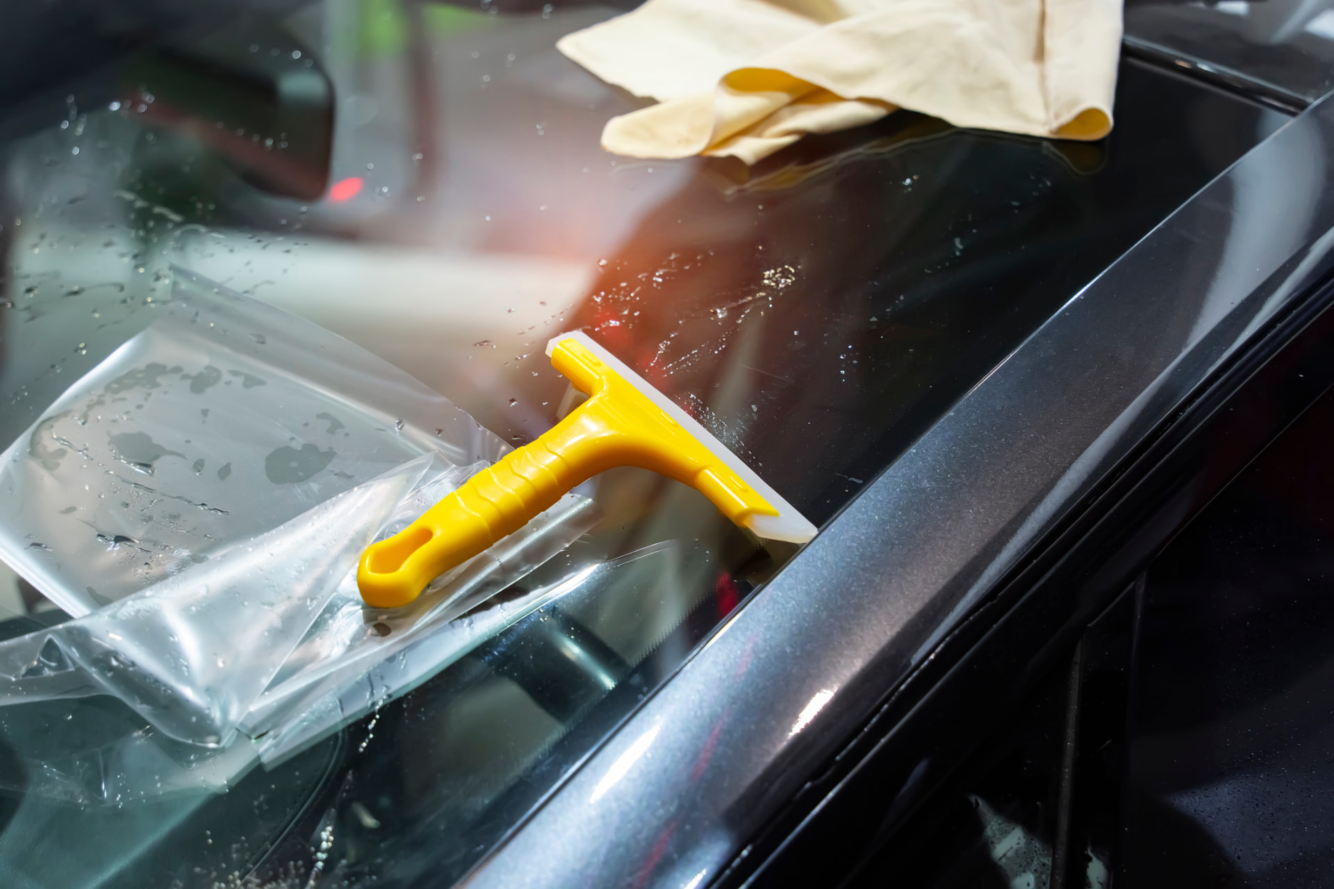 Window film and squeegee during a tint installation