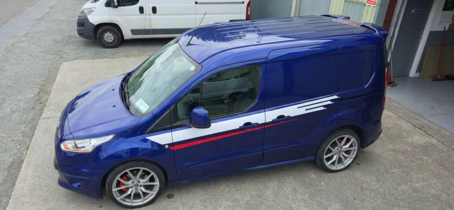 High three-quarter view of a blue Transit Connect showing dark tinted load-bay glass